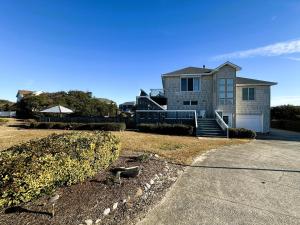 a large house with a driveway in front of it at KH101 - Shells in Kitty Hawk