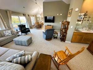 a living room with a couch and chairs and a kitchen at KH101 - Shells in Kitty Hawk