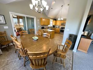 a kitchen and dining room with a wooden table and chairs at KH101 - Shells in Kitty Hawk