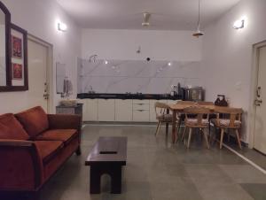 a living room with a couch and a table at Virudravilla in Jodhpur