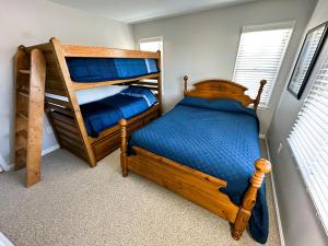 a bedroom with two bunk beds and a ladder at KH101 - Shells in Kitty Hawk +13 photos