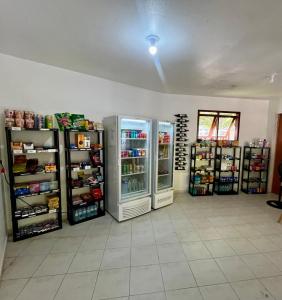 a store with two refrigerators in a room at Pousada Maliale in Ilha de Boipeba