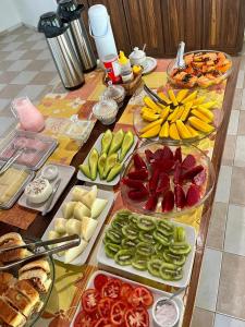 a table topped with different types of vegetables and food at Pousada Maliale in Ilha de Boipeba