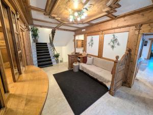 a living room with a couch and a staircase at Pension Atlantic in Badia