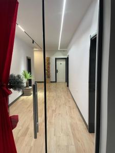 a hallway of an office with a glass door at Kremelo Hotel in Berat +23 photos
