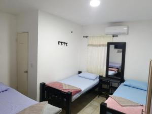 En eller flere senge i et værelse på Hostal Mastcoy