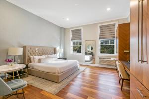a bedroom with a bed and a table and chairs at Hotel Suites at Vanderbilt in Westbury +32 photos