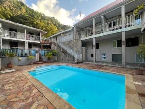 a large swimming pool in front of a building at Résidence Roxelle in Saint-Pierre