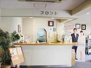 two people standing at a counter in a store at Hotel Higashihiroshima Hills Saijo in Higashihiroshima