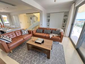 a living room with a couch and a coffee table at Luxury Lagada Loft Sea Views in Pilalímata