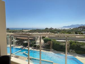 a view of a swimming pool from a balcony at Luxury Lagada Loft Sea Views in Pilalímata
