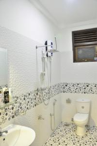 a bathroom with a shower and a toilet and a sink at Villa Mount View in Unawatuna