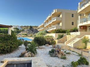 a resort with a garden and a building at Luxury Lagada Loft Sea Views in Pilalímata