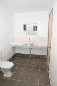 a bathroom with a sink and a toilet at Evis Resort at Nggatirana Island in Halisi