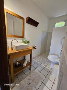 a bathroom with a sink and a toilet at Casa Ébano Brasileiro in Porto Seguro +7 photos