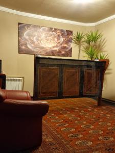a living room with a large painting on the wall at Pension Pale' Bach in Bad Hersfeld