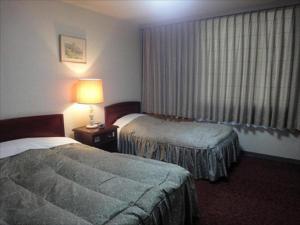 Postel nebo postele na pokoji v ubytování Hotel CROWN HILLS MIYOSHI