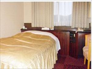 Postel nebo postele na pokoji v ubytování Hotel CROWN HILLS MIYOSHI