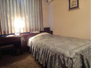 Postel nebo postele na pokoji v ubytování Hotel CROWN HILLS MIYOSHI