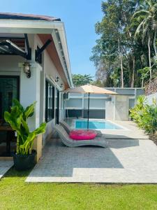 a house with a pool and a red frisbee at Aonang Peace Pool Villa in Ban Khlong Haeng