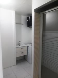 a bathroom with a sink and a toilet and a mirror at dragon des iles in Pointe-à-Pitre