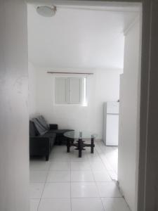 a living room with a couch and a table at dragon des iles in Pointe-à-Pitre