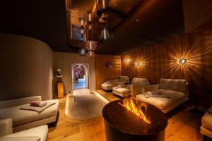 a living room with couches and a fire place at Hotel Trisanna in Ischgl