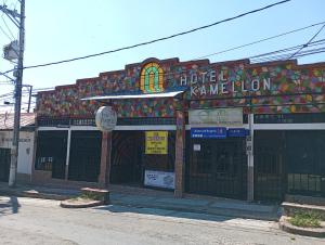 a building with a sign in front of it at Hotel KAMELLON in Estación El Salto