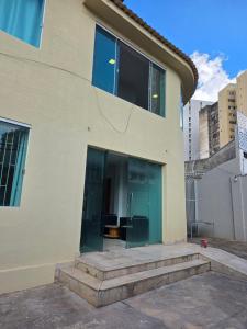 a building with glass doors on the side of it at Cerrado Hostel in Goiânia