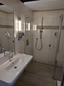 a bathroom with a sink and a shower at Wohnwagen mit feststehendem Vorzelt in Fehmarn +14 photos