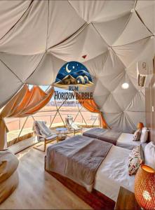 a room with a bed in a tent at RAM HORlZON BUBBLE LUXURY CAMP in Wadi Rum