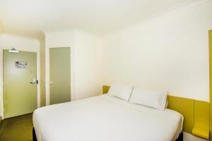 Postel nebo postele na pokoji v ubytování Imperial Motel Windsor