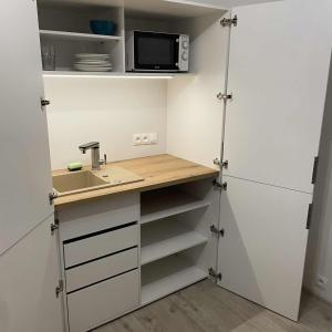 a small kitchen with a sink and a microwave at Zu Hause in Vrbov +15 photos