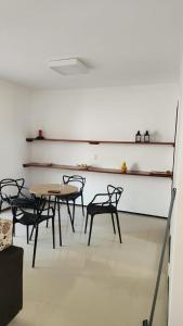 a group of tables and chairs in a room at Dúplex Lagoa in Paracuru