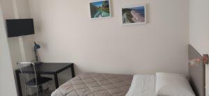 a bedroom with a bed and two pictures on the wall at Daisy in Pescara