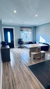 a large room with a table and a chair at Explore Rooms JFK in Locust Manor
