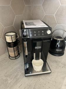 a black coffee maker sitting on a counter at La Madeleine centre historique de Troyes in Troyes +23 photos