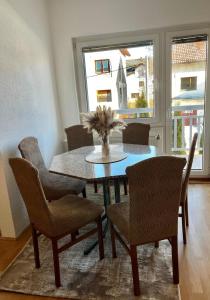 a dining room with a table and chairs and a window at Apartman Lara in Kupres +5 photos