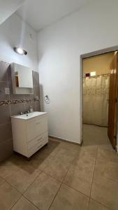 ein Badezimmer mit einem weißen Waschbecken und einem Spiegel in der Unterkunft El descanso in El Rodeo