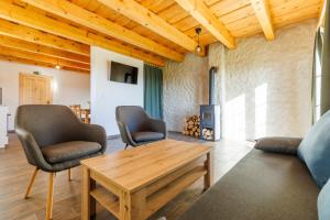a living room with a couch and chairs and a table at Apartmány U Hešů in Horní Lipka