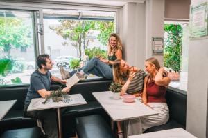 a group of people sitting at a table in a restaurant at Mad Monkey Potts Point in Sydney