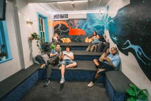 a group of people sitting on steps in a room at Mad Monkey Potts Point in Sydney +50 photos