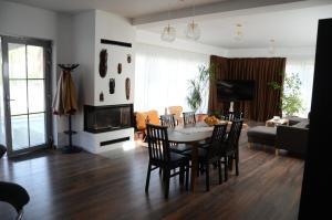 a living room with a table and chairs and a couch at Vila Bella in Oradea