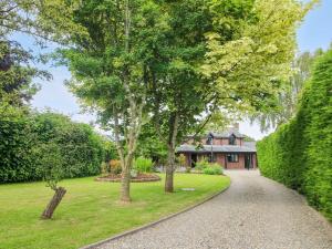 a driveway leading to a house with trees at 1 Clarkes Lane in Oswestry