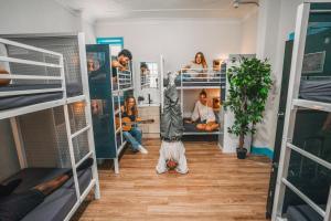 a group of people in a room with bunk beds at Mad Monkey Potts Point in Sydney