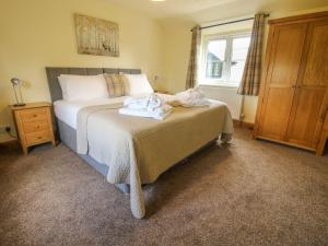 a bedroom with a bed with towels on it at 1 Clarkes Lane in Oswestry
