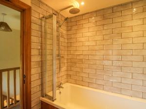 a bathroom with a tub and a glass shower at 1 Clarkes Lane in Oswestry +23 photos