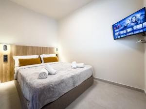 a bedroom with a large bed with towels on it at Preveza Central Stay in Preveza