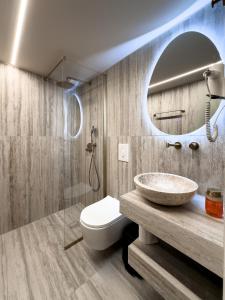 a bathroom with a sink and a mirror at Preveza Central Stay in Preveza