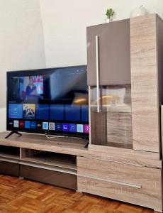 a flat screen tv sitting on a entertainment center at Cozy and fully equipped flat in the centrum in Essen